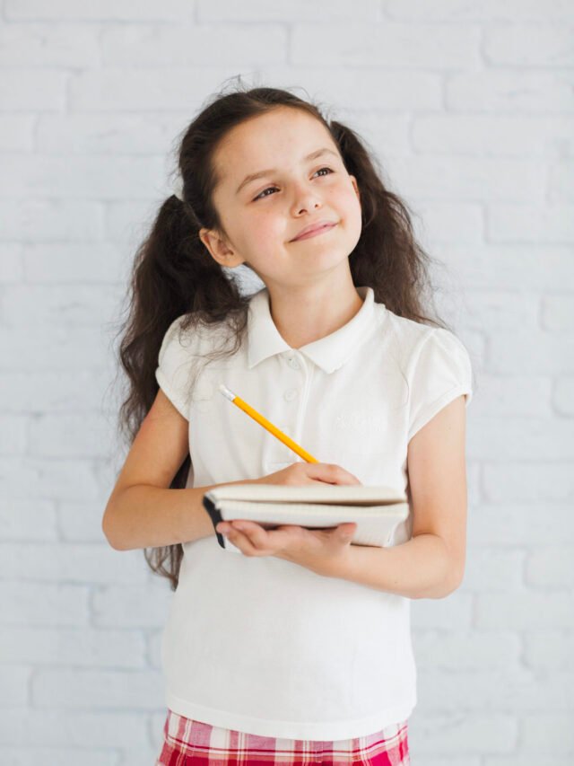 brunette-girl-holding-notebook-pen-looking-away